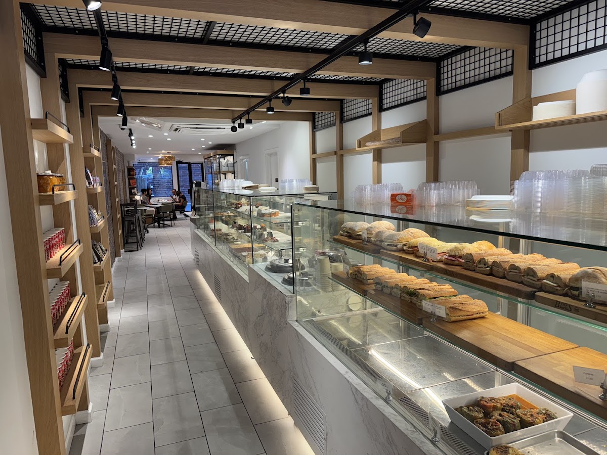 The interior café room at The Bakery Room: long marble counter, displays, café seating in the back